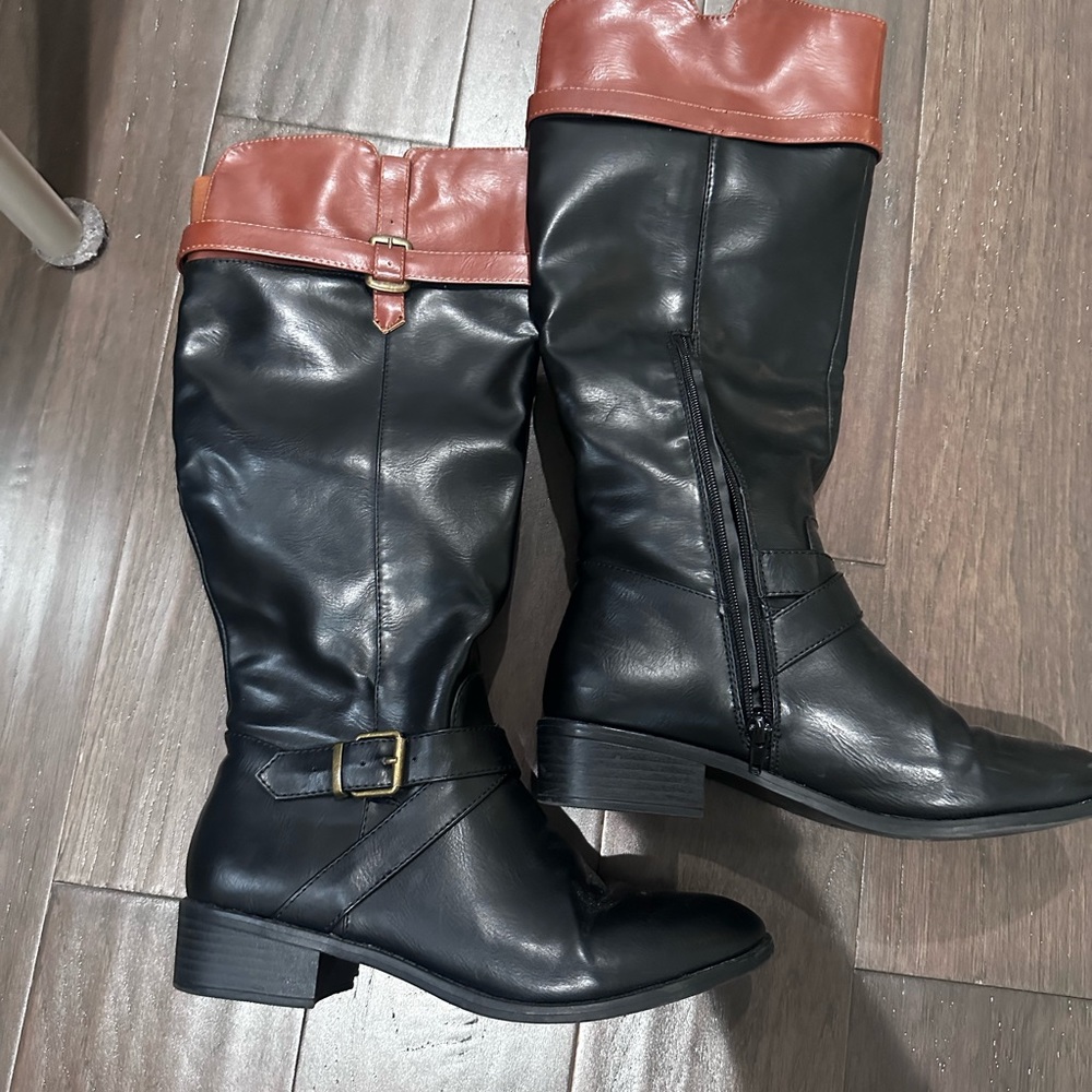 Tan and black riding boots